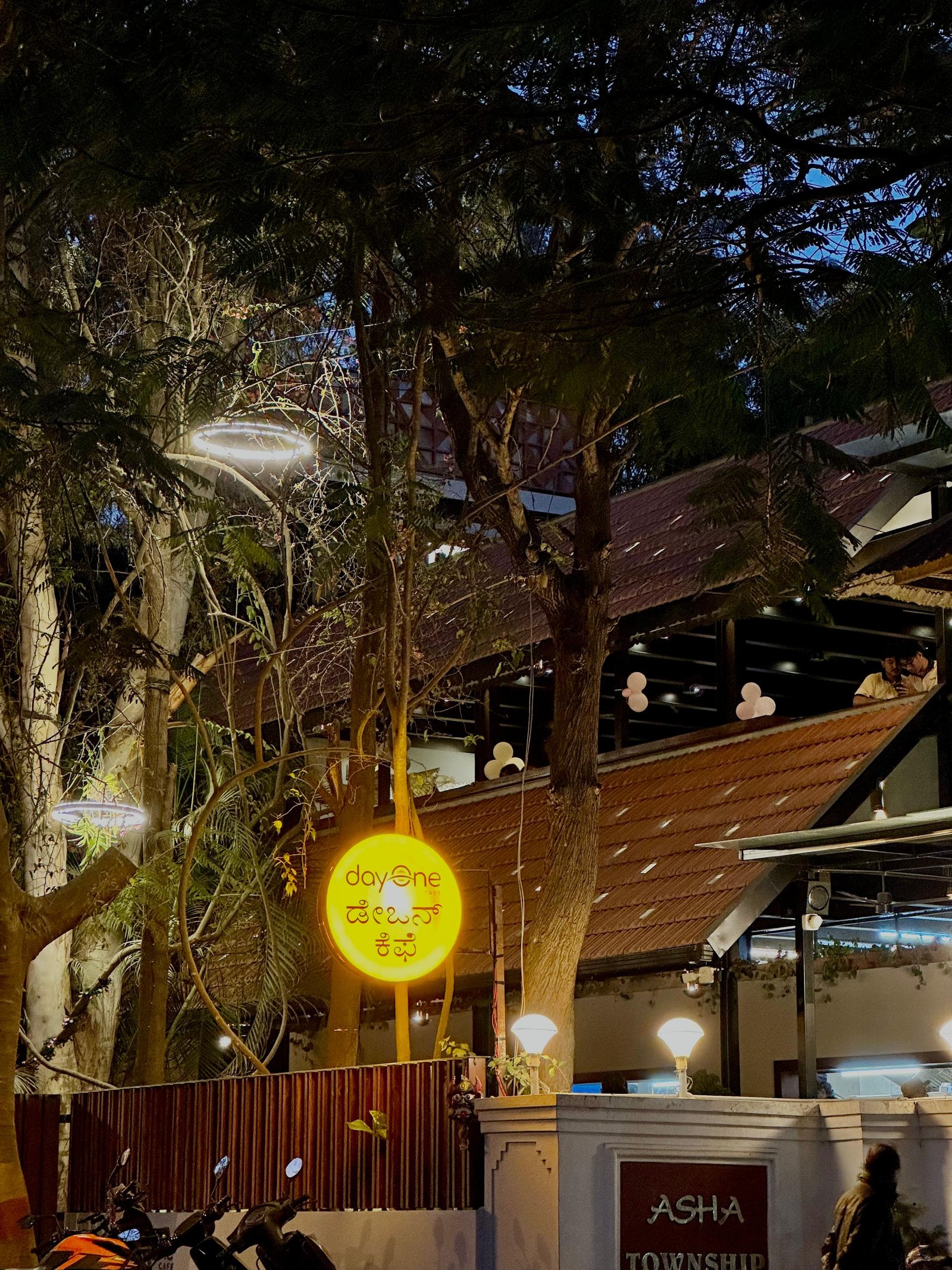 Night exterior with illuminated Day One Cafe sign