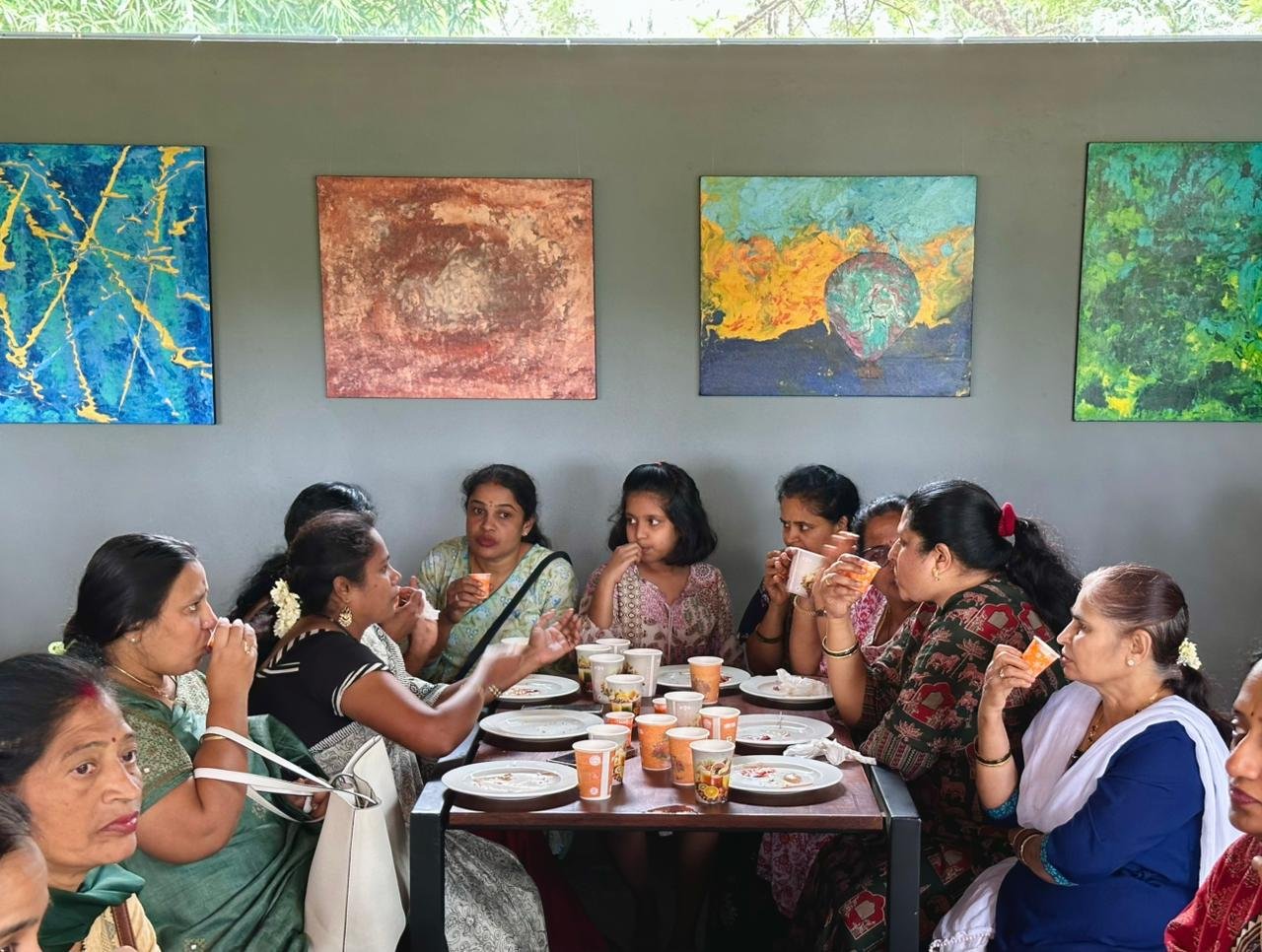 Community gathering at Day One Cafe with colorful art on walls